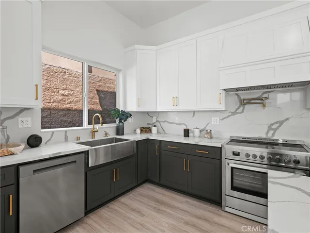 a kitchen with a sink stove and cabinets