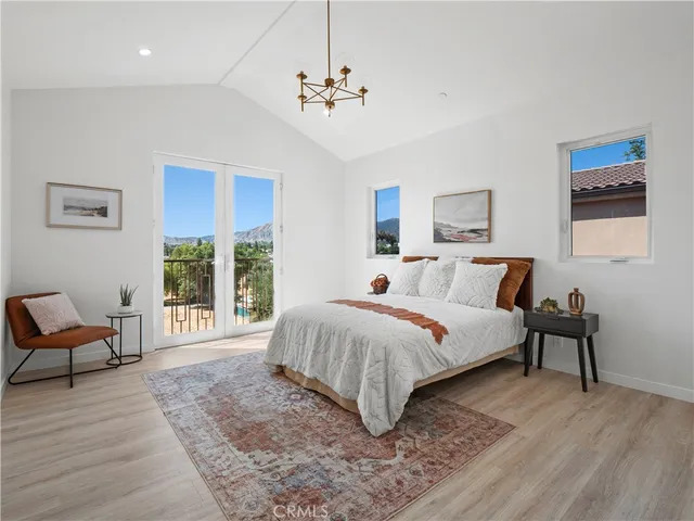 a bed room with a bed and a chair