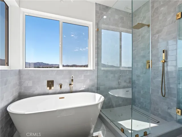a white bath tub sitting next to a shower