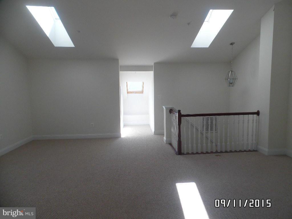 7636 Elmcrest Road Hanover, MD 21076 - Photo 14 of 18 a view of a livingroom with wooden floor and a window