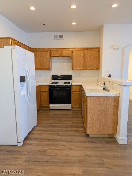 2201 Ramsgate Drive, Unit 116 Henderson, NV 89074 - Photo 9 of 13 This bright kitchen features wood cabinetry and durable flooring, perfect for everyday living.