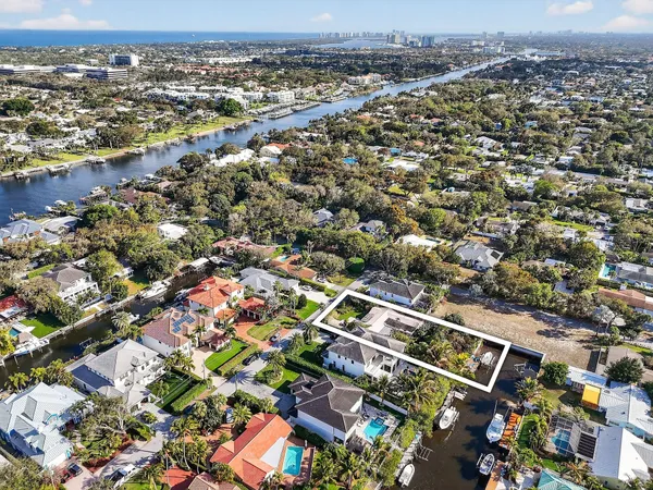 an aerial view of residential houses with outdoor space and swimming pool