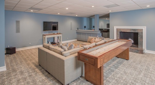 4 Summit Road Weston, MA 02493 - Photo 19 of 30 a living room with kitchen island furniture and a fireplace