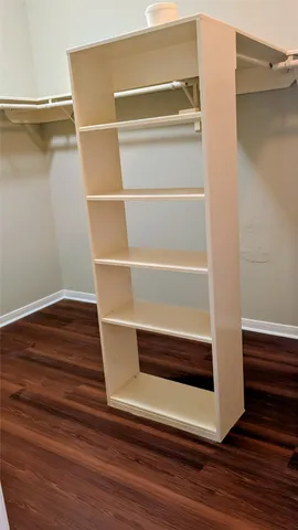 a view of walk in closet with empty racks