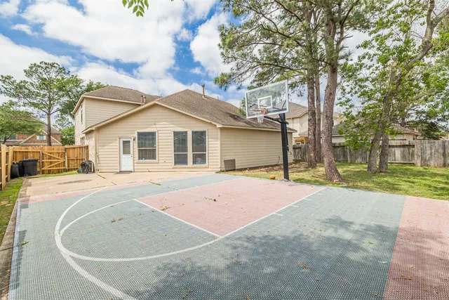 a front view of a house with yard and trees