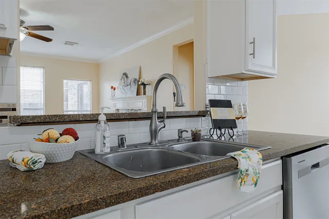 a kitchen with sink a stove and cabinets