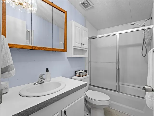 a bathroom with a sink toilet and a mirror