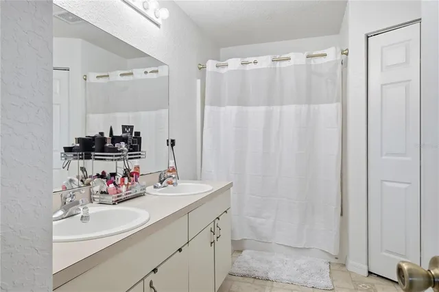 a bathroom with a sink double vanity and a mirror