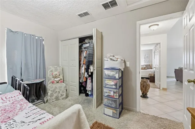 a bedroom with furniture and a closet