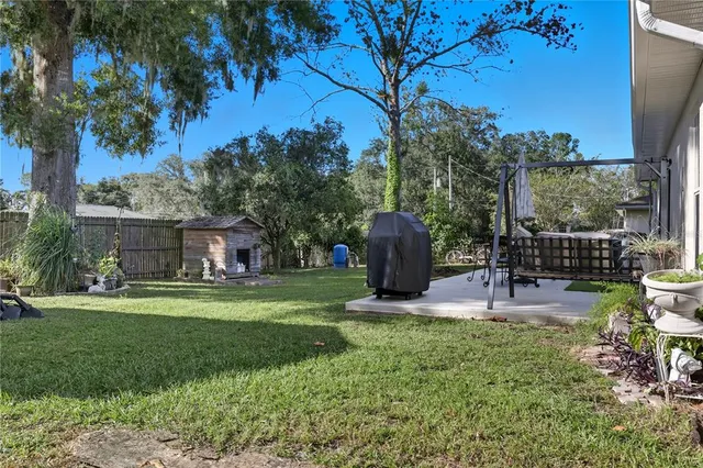 a swimming pool with barbeque oven and outdoor seating