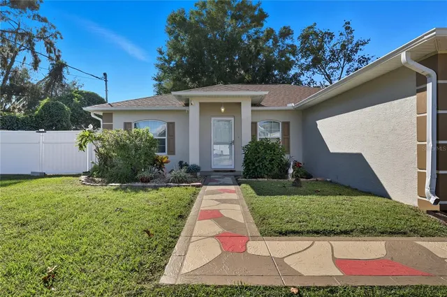 a view of backyard of house with green space