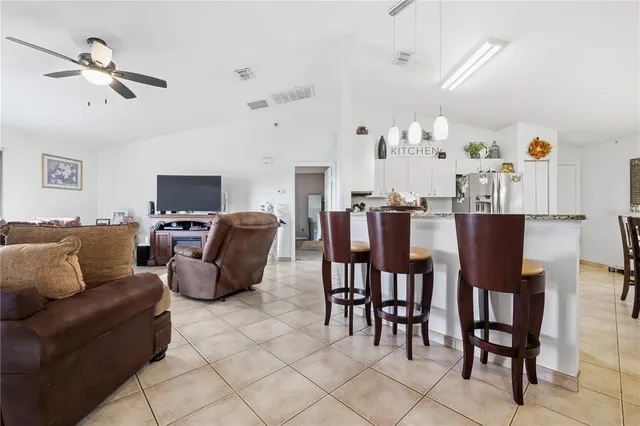 a living room with furniture a dining table and a fireplace