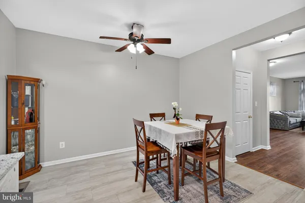 a kitchen with granite countertop white cabinets and stainless steel appliances
