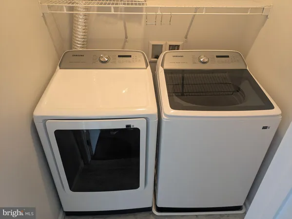 a bedroom with a bed a window and a rug