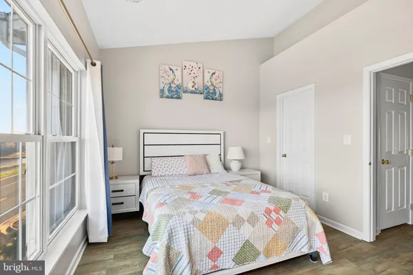 a bedroom with a large bed and a window