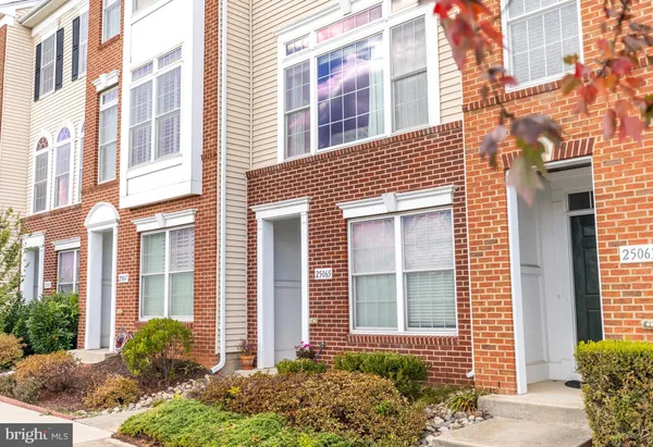 a view of a brick building next to a yard
