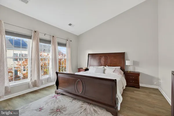 a bedroom with a bed and a mirror