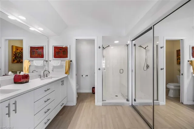 a bathroom with a double vanity sink mirror and shower