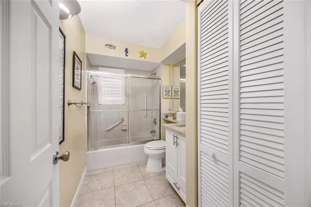 a bathroom with a granite countertop sink a toilet and shower