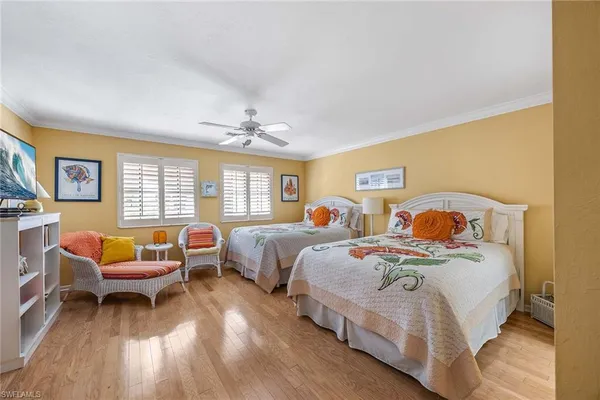 a bedroom with two beds and a window