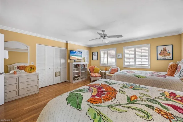 a bedroom with furniture and a large window