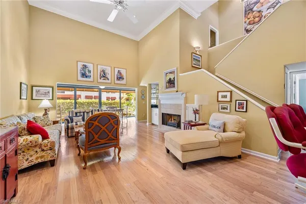a living room with furniture a fireplace and a table
