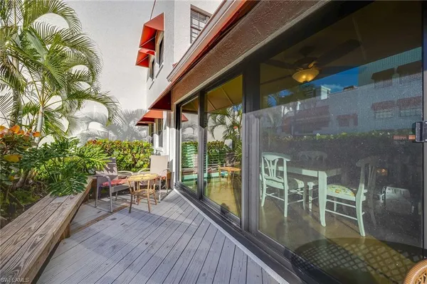 a balcony with chairs and wooden floor