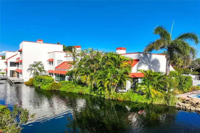 a swimming pool with outdoor seating and plants