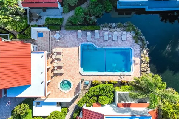a view of an house with swimming pool and sitting area