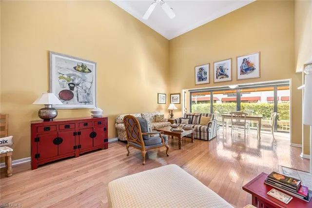 a living room with furniture and a floor to ceiling window