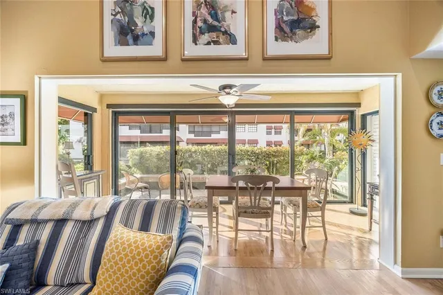 a living room with furniture and a large window with outer view