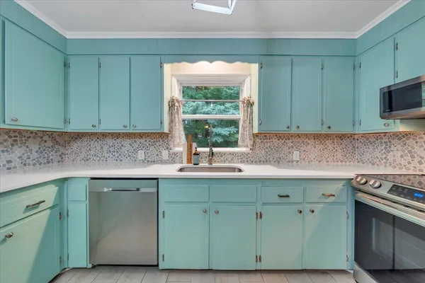 a kitchen with a sink and a refrigerator