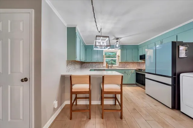 a view of a dining room with furniture and a potted plant