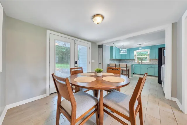 a dining room with furniture and wooden floor