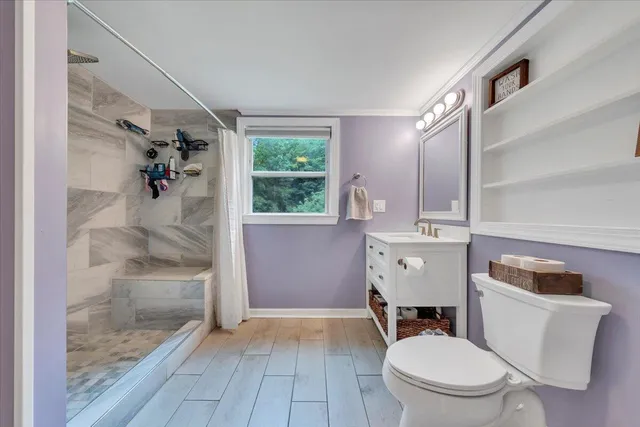 a bathroom with a glass shower door