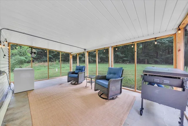a view of a house with a yard and sitting area