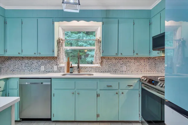 a kitchen with granite countertop a sink and stainless steel appliances