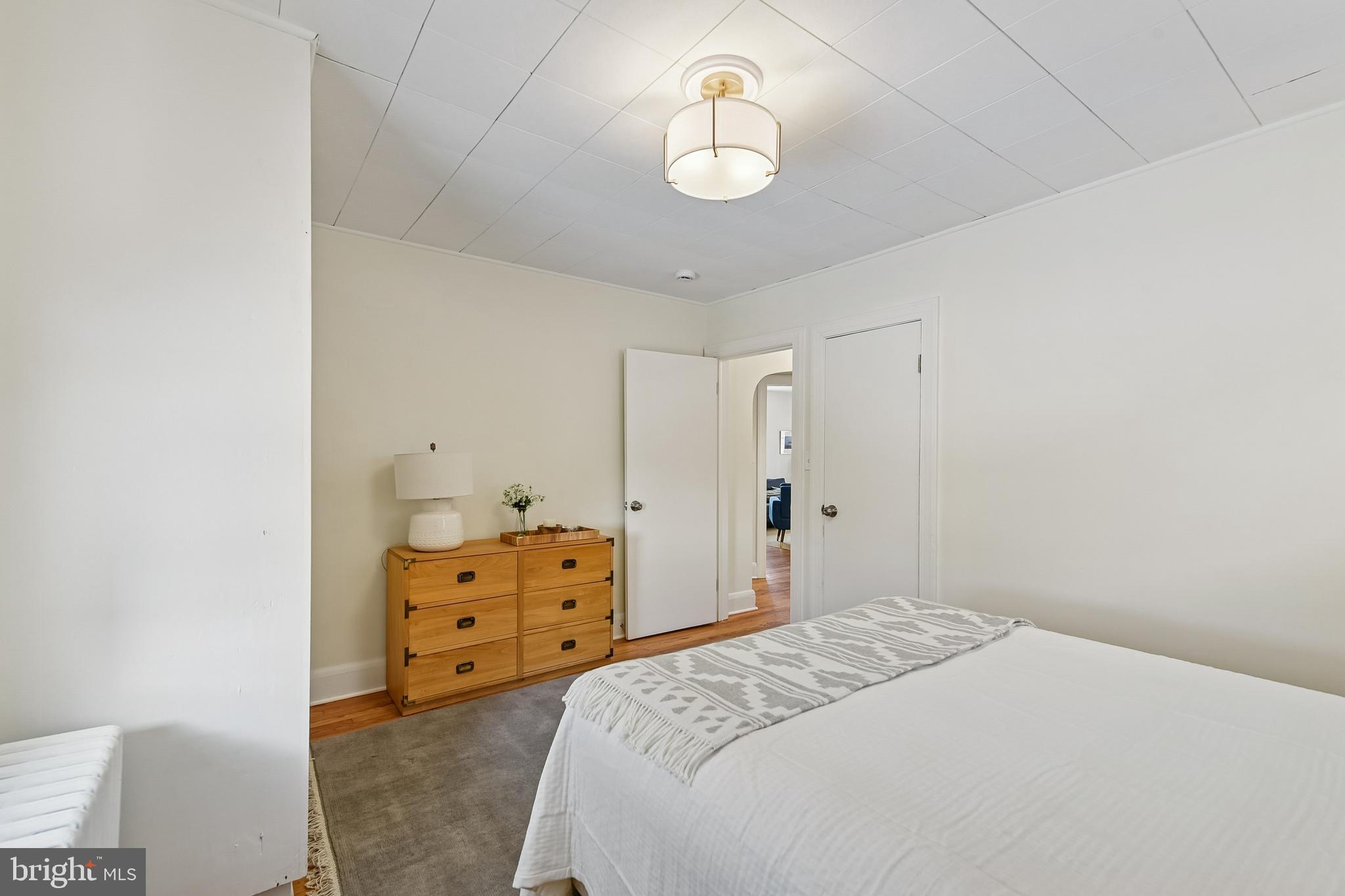 100 Margaret Avenue Baltimore, MD 21221 - Photo 16 of 44 a bedroom with a bed and a chandelier
