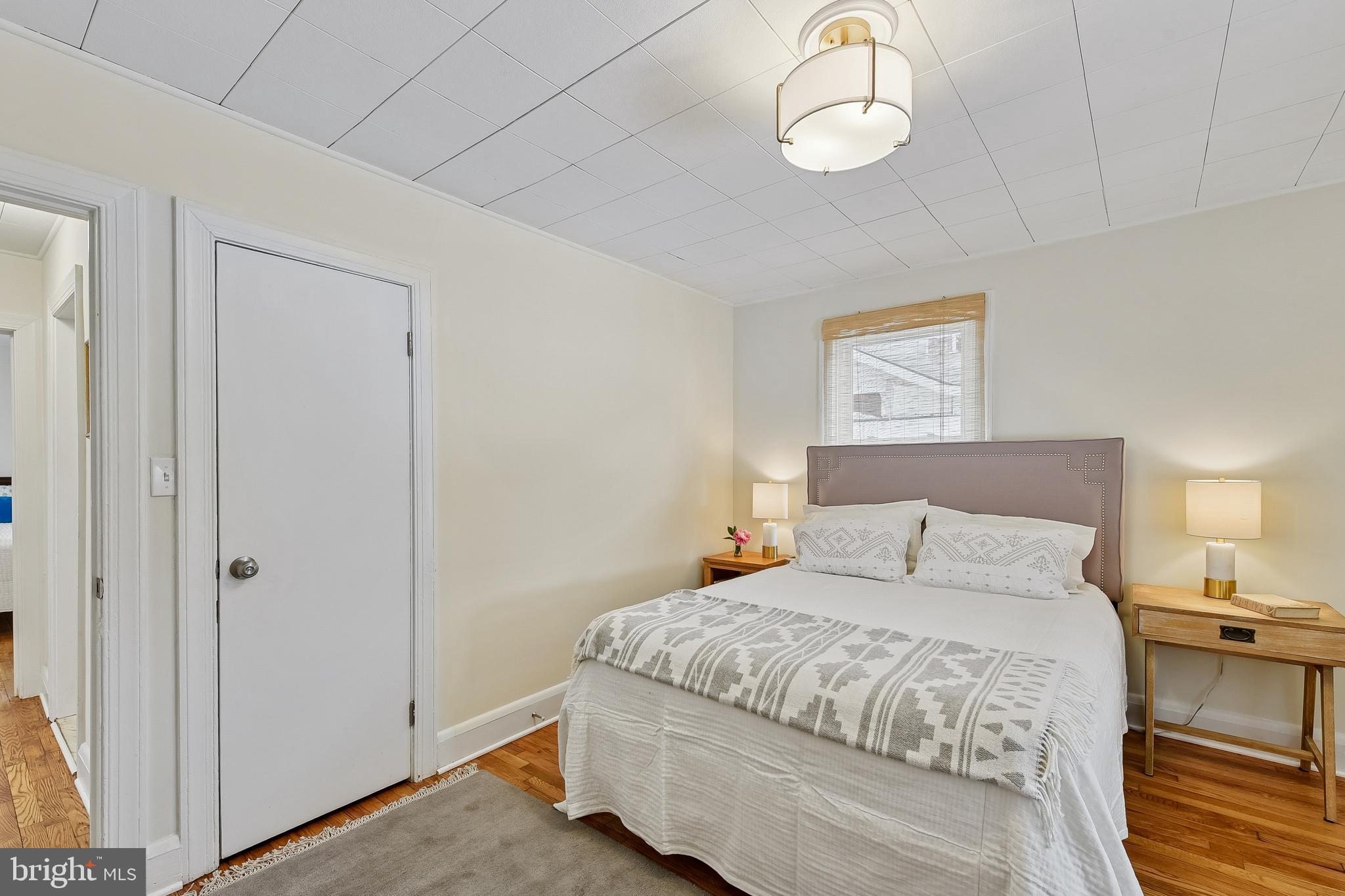 100 Margaret Avenue Baltimore, MD 21221 - Photo 17 of 44 a bedroom with a bed and a chandelier