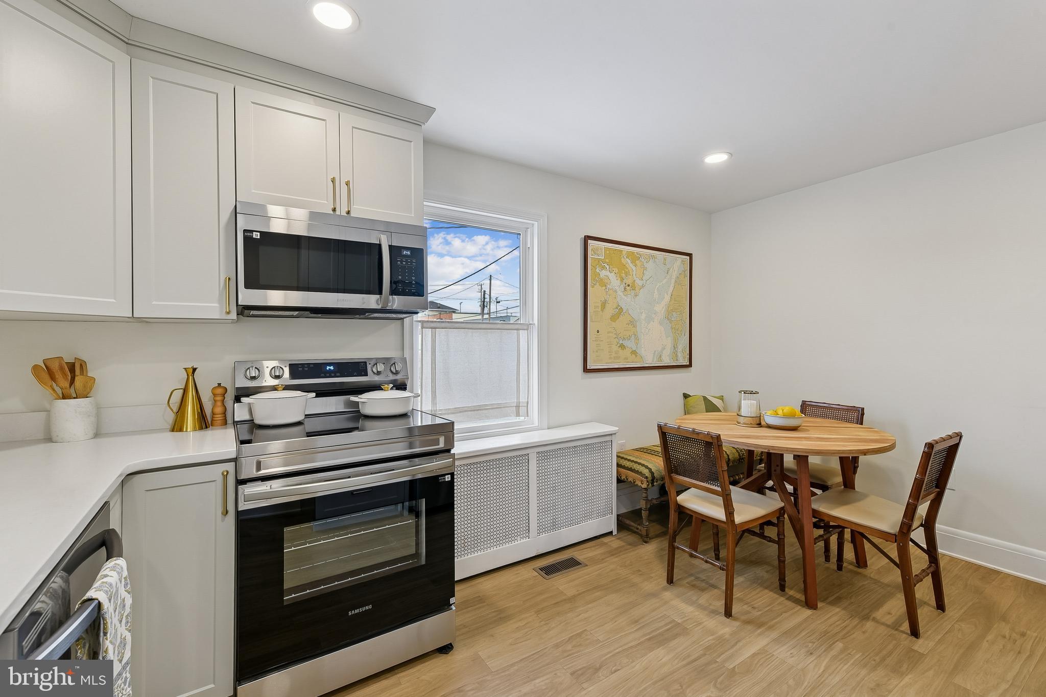 100 Margaret Avenue Baltimore, MD 21221 - Photo 6 of 44 a kitchen with a stove a sink and wooden floor