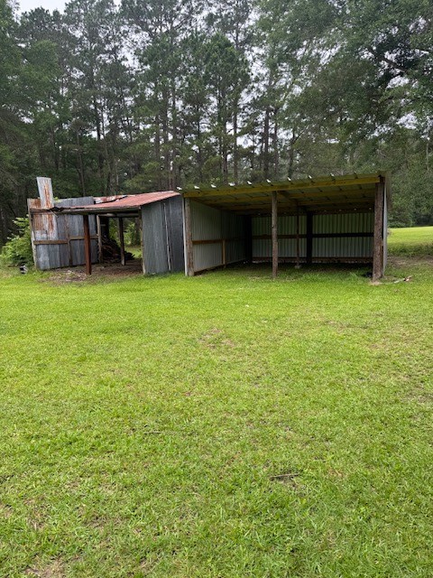 9004 Farm To Market 62 Corrigan, TX 75939 - Photo 4 of 27 a backyard of a house with table and chairs
