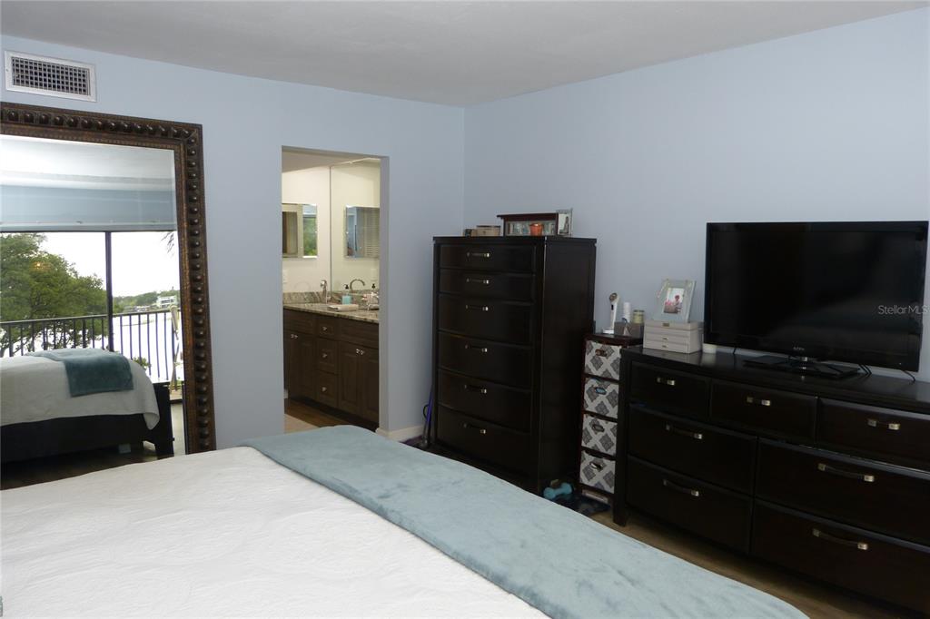 2700 Bayshore Boulevard, Unit 11105 Dunedin, FL 34698 - Photo 15 of 33 a bedroom with a bed and a flat screen tv