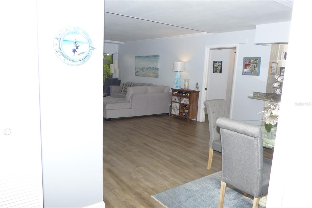 2700 Bayshore Boulevard, Unit 11105 Dunedin, FL 34698 - Photo 7 of 33 a living room with furniture and a wooden floor