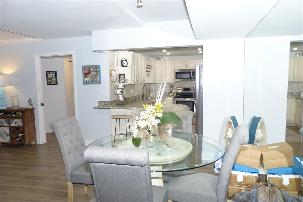2700 Bayshore Boulevard, Unit 11105 Dunedin, FL 34698 - Photo 9 of 33 a dining room with furniture and wooden floor