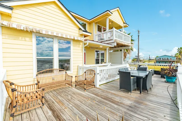 a view of a dinning table and chairs on the deck
