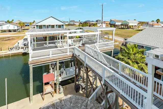 a living room with patio furniture and a flat screen tv