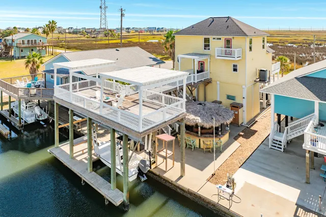 a view of a house with pool and chairs