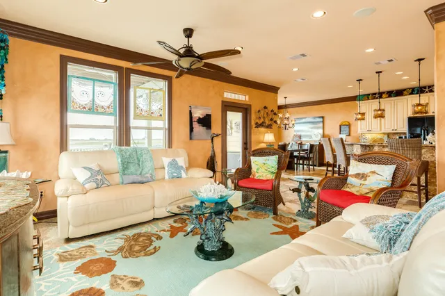 a kitchen with stainless steel appliances kitchen island granite countertop a refrigerator oven a stove top oven and a dining table with wooden floor