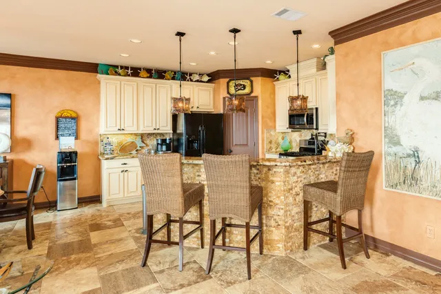 a kitchen with stainless steel appliances granite countertop a sink stove and cabinets