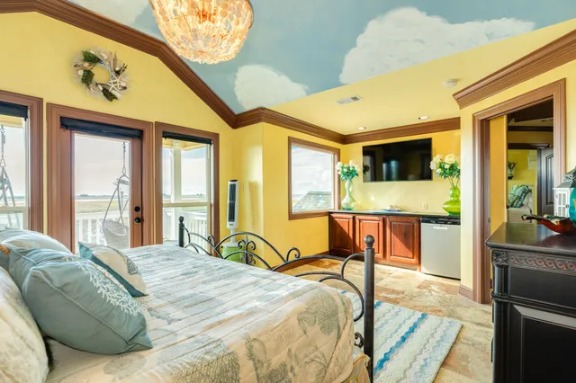 a bedroom with a bed and painting on the wall